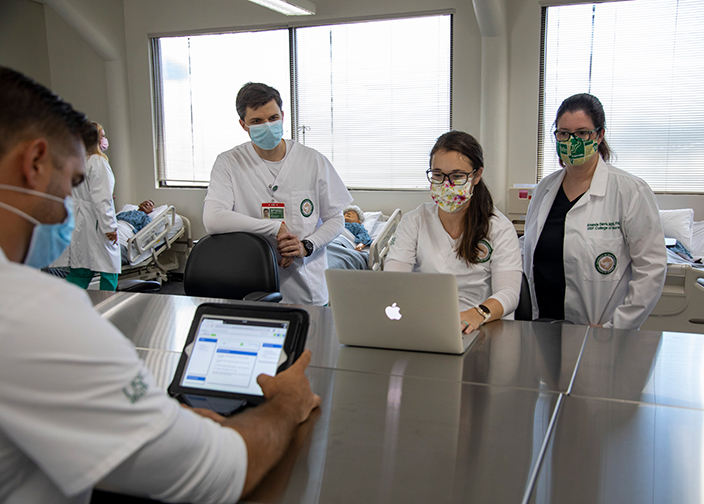 students in the nursing program working on laptops