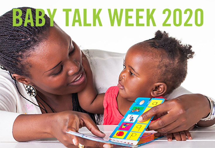 Adult woman reading a book to a young child.