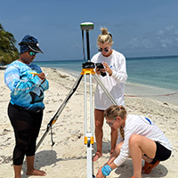 The USF team sets up equipment to study beach erosion in Belize