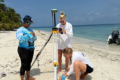 Students setting up to study the erosion at a reef island