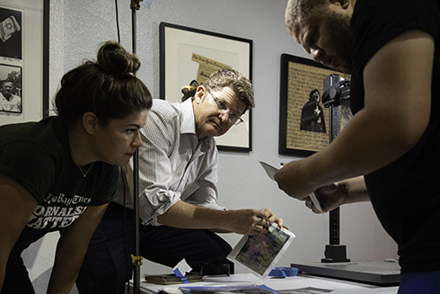 People looking over photographs