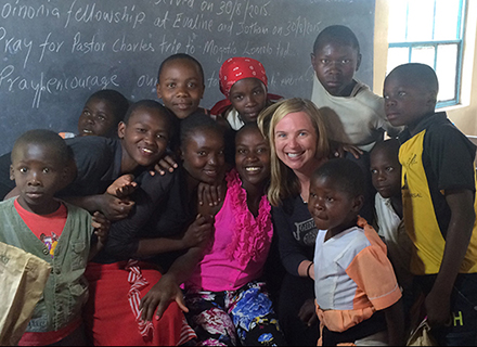 Psychology professor Tiffany Chenneville with students in a classroom in Kenya