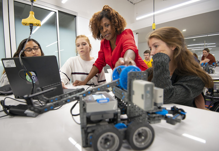 Sandra Vernon-Jackson engaging with students during the STEM robotics summer camp.