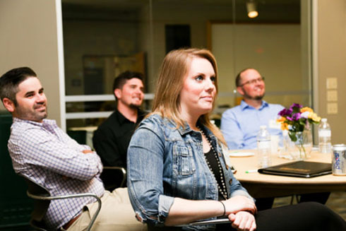 Students sitting at a table at the workshop.