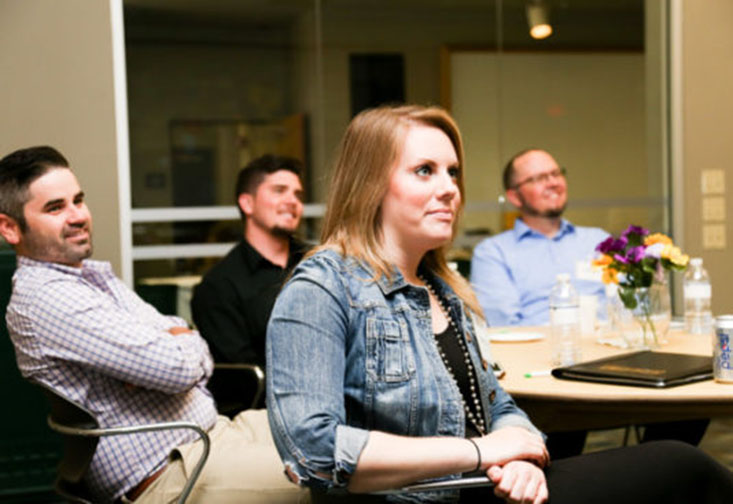 Students sitting at a table at the workshop.