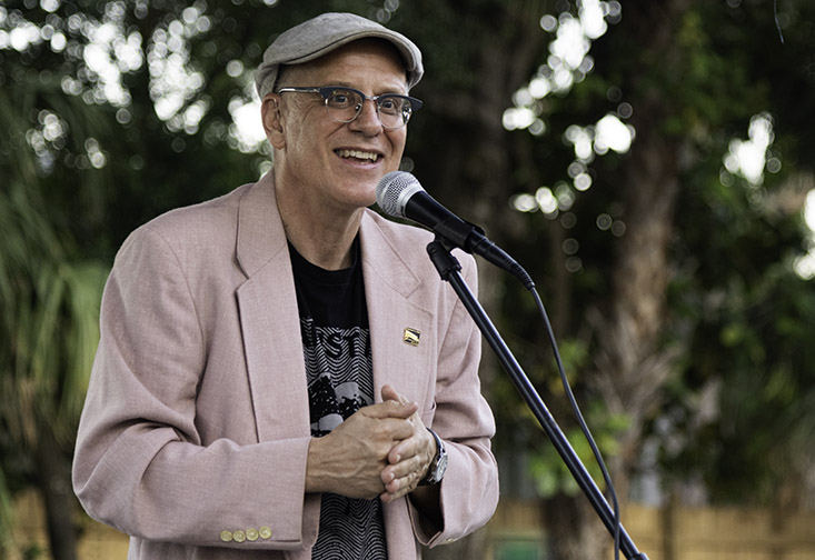 Thomas Hallock speaking into a microphone