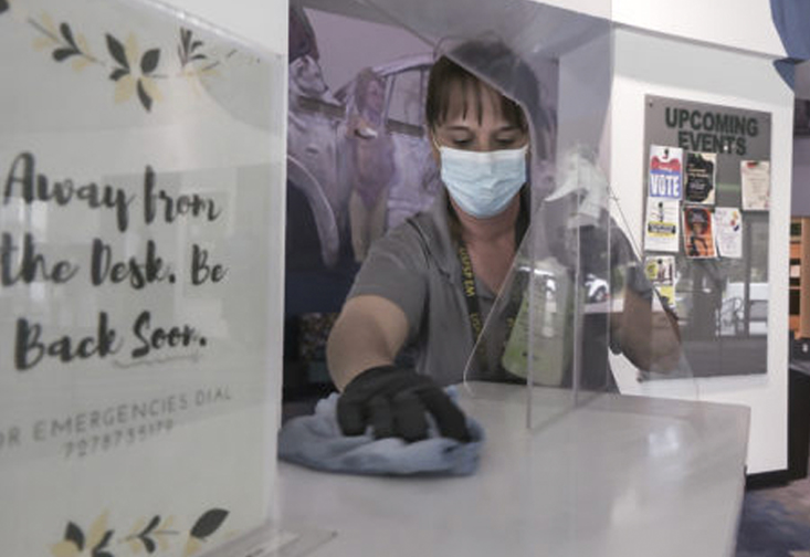 Facilities worker cleaning a counter