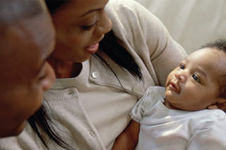 A mother and father looking at their baby
