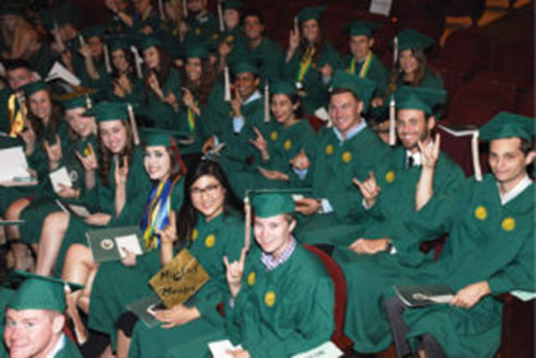 Students in caps and gowns at commencement