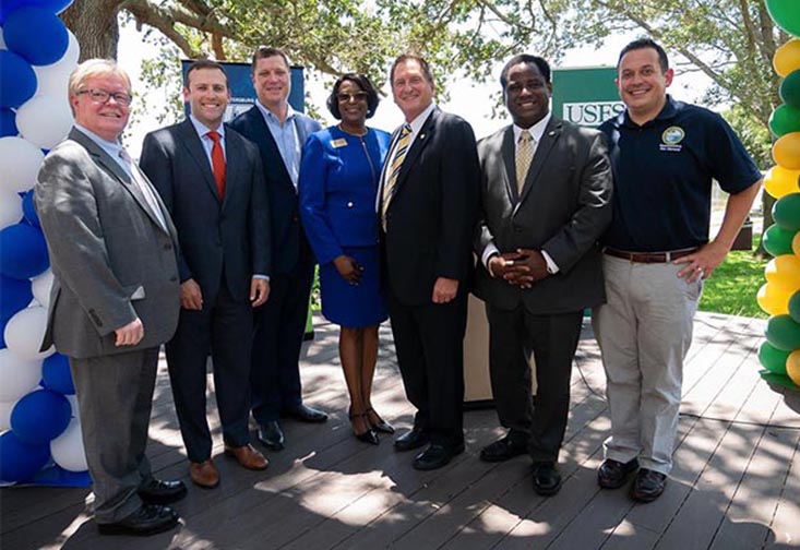 Dr. Tadlock standing with legislatures