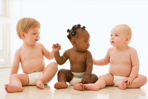 Three babies sitting on the floor