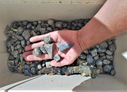 A cooler filled with small lead weights that Nawrocki found on the sea floor.