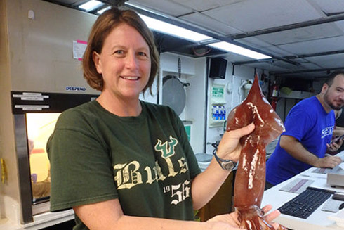 Heather Judkins holding a recently captured squid.