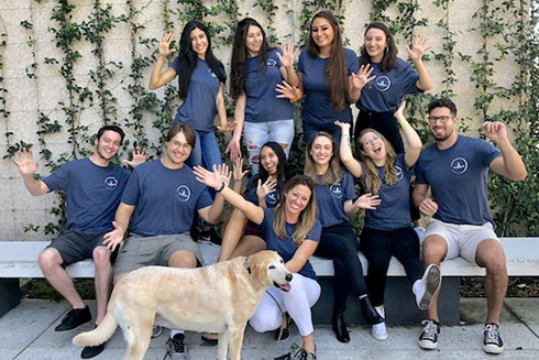 Professor Lindsay Rodriguez with USFSP students who work in her lab and her dog.