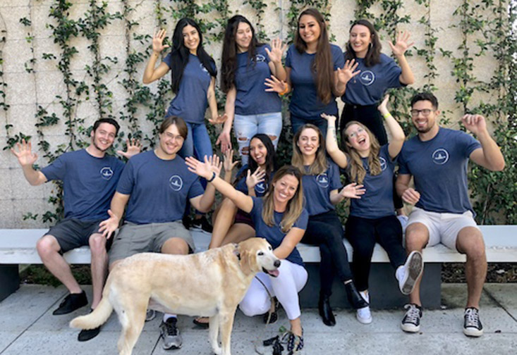 Professor Lindsay Rodriguez with USFSP students who work in her lab and her dog.