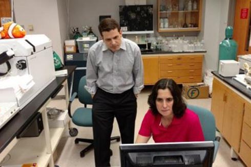 USFSP Neighborhood News Bureau director Bernardo Motta and College of Marine Science research associate Dr. Kelly Quinn look over findings of tests