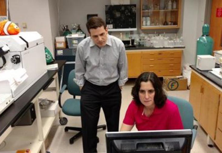 USFSP Neighborhood News Bureau director Bernardo Motta and College of Marine Science research associate Dr. Kelly Quinn look over findings of tests