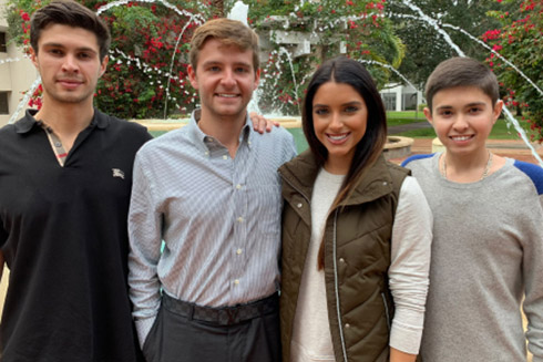 Brandon, Dean, Jonathan and Myah Luper on campus in front of the fountain.