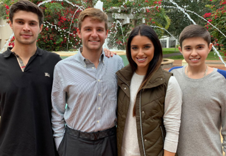 Brandon, Dean, Jonathan and Myah Luper on campus in front of the fountain.