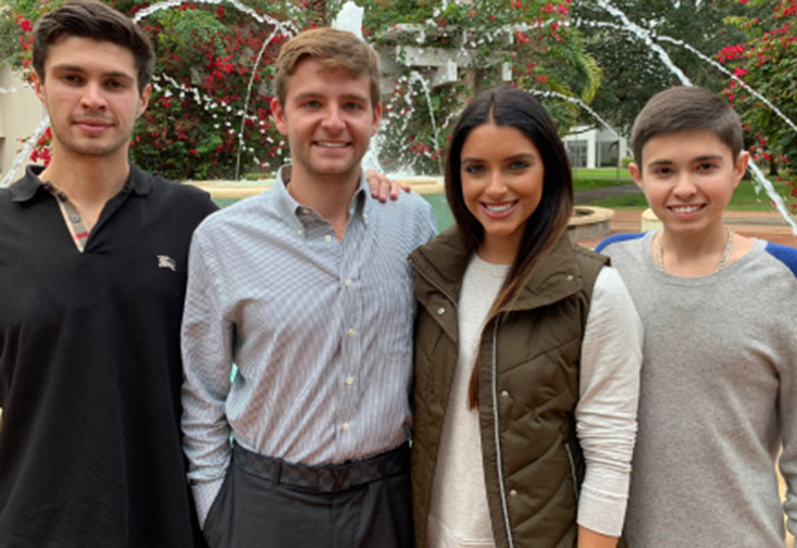 Brandon, Dean, Jonathan and Myah Luper on campus in front of the fountain.