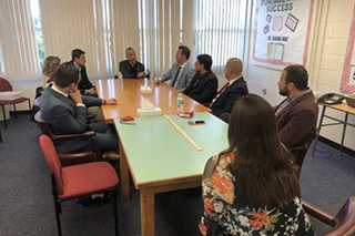 Delegates sitting at a conference room table