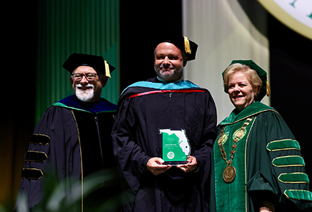 mathis receiving award at commencement 