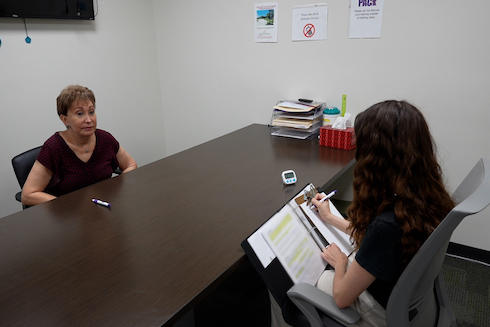 A trained psychology student administers a cognitive assessment.