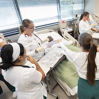 Students working in the nursing simulation lab.