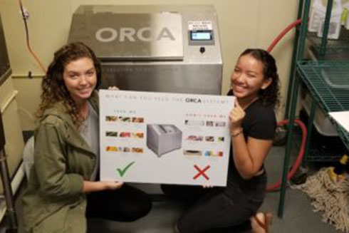 Members of the Student Green Energy Fund pose in front of the newly installed ORCA.