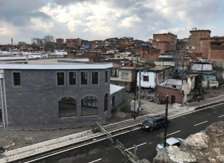 Townhouses (left) under construction in the ancient walled district of Sur. 