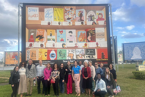 group of adults in front of artwork at poytner park