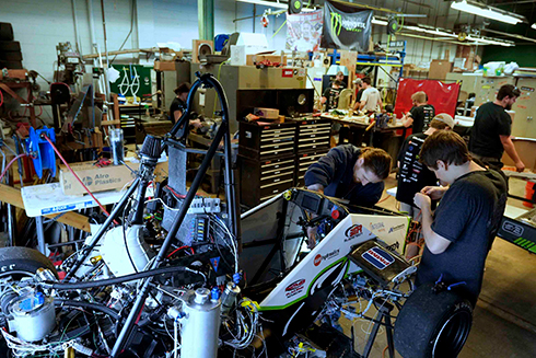 Bulls Racing team working on a car at the shop.