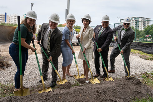 Leadership on the USF St. Petersburg campus wearing hard hats and holding shovels at the groundbreaking ceremony.