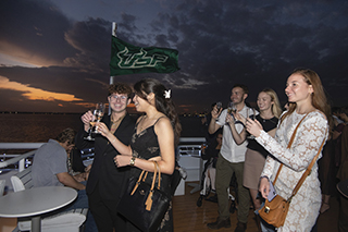 Students celebrating on sunset cruise