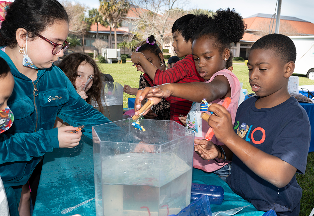 Group of kids participating in a science experiment at the science festival 