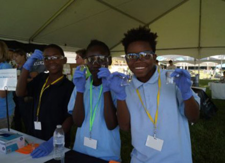 Students holding up vials at the Science Fest