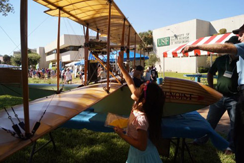 Girl looking at plane at Science Fest.