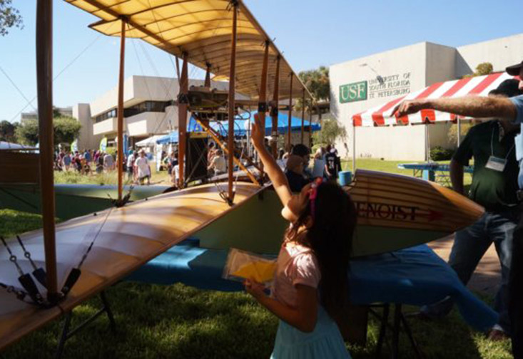 Girl looking at plane at Science Fest.