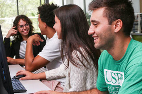 Students doing group work at a computer.