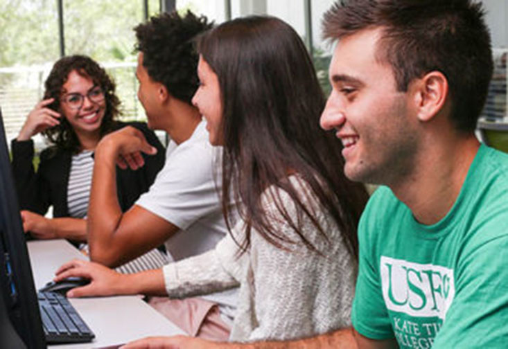 Students doing group work at a computer.