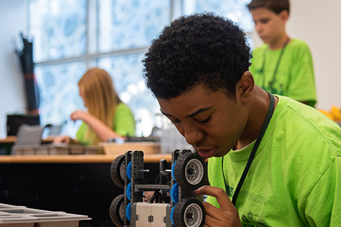 A student programs a robot during the STEM robotics camp at the USFSP College of Education.