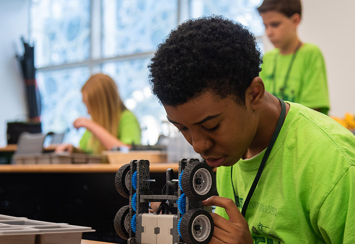 A student programs a robot during the STEM robotics camp at the USFSP College of Education.