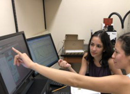 Students Shayra Antia and Frances Rodriguez analyze data captured during their summer research project.