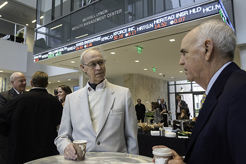 Two people talking at a table during the event.