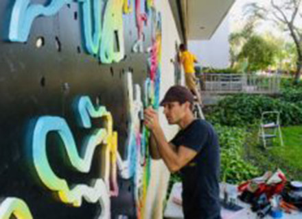 Kenny Jensen working on a sculpture on campus.