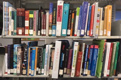 Some of the textbooks in the USF St. Petersburg Library’s reserve collection.