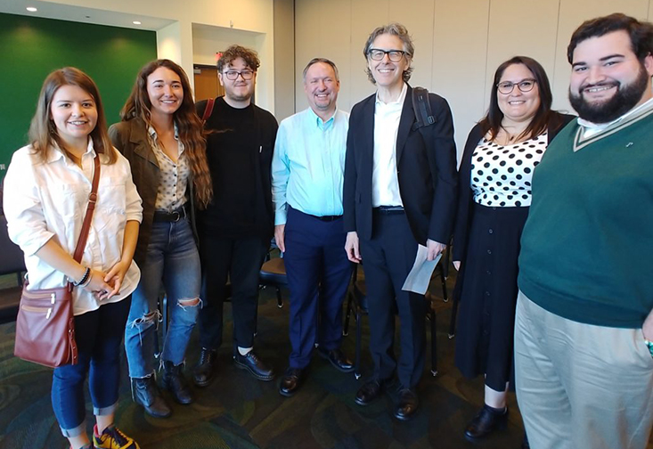 Ira Glass posing with USF St. Petersburg students