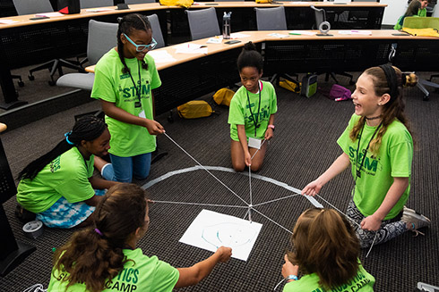 Students working together at the robotics camp