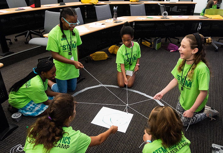 Students working together at the robotics camp