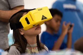 Child with a VR headset on looking up
